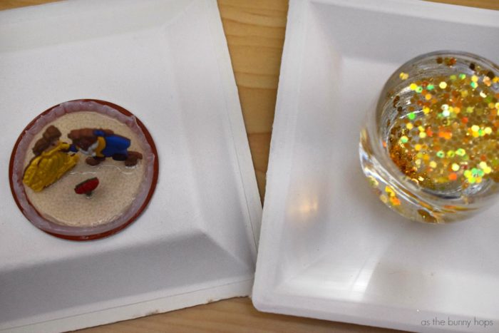 Make an easy and adorable DIY Beauty and the Beast Snow Globe with decorative buttons! 