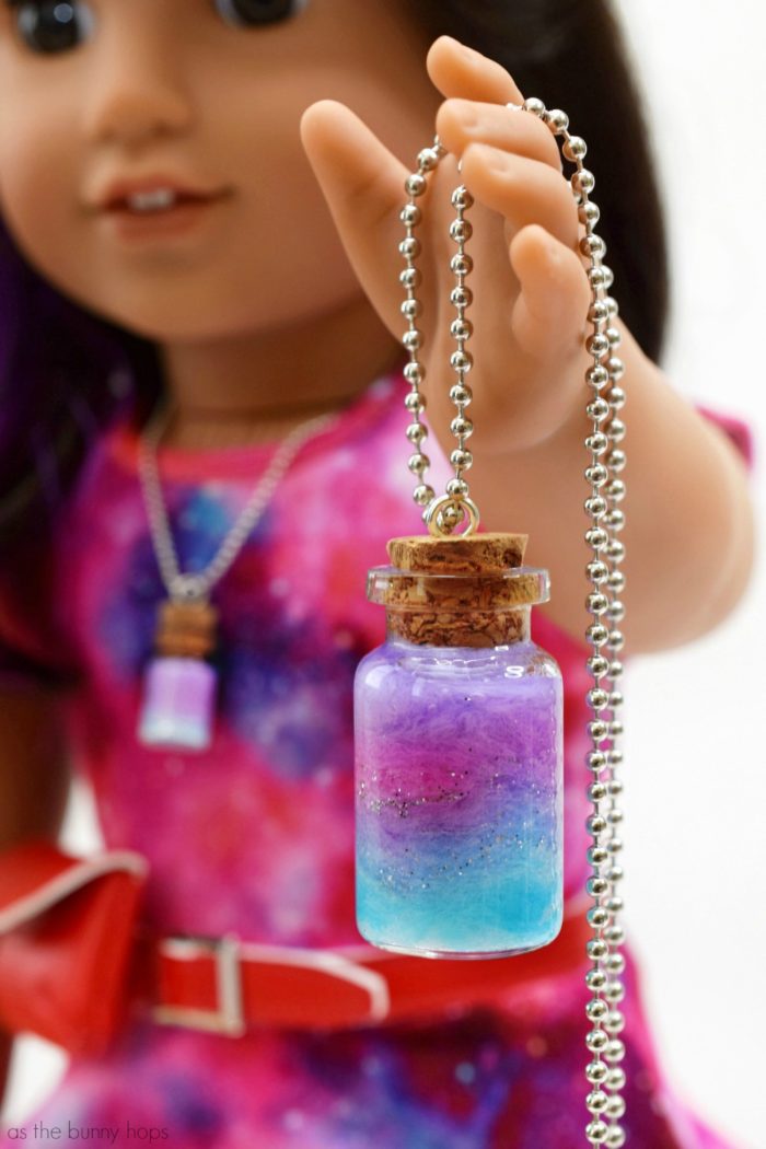 Celebrate Luciana Vega, American Girl's Girl of the Year 2018, by making a set of doll and me nebula pendants! This easy DIY is a totally kid-friendly craft! It's also makes a great science themed activity!