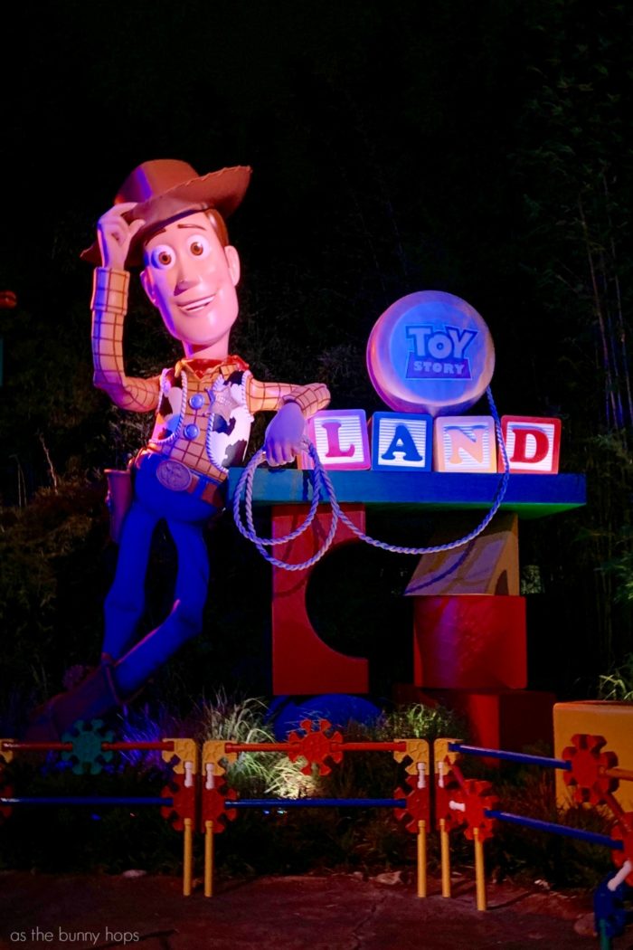 Toy Story Land Entrance at night. Find out why it's worth it to visit Toy Story Land twice on your visit to Walt Disney World! 