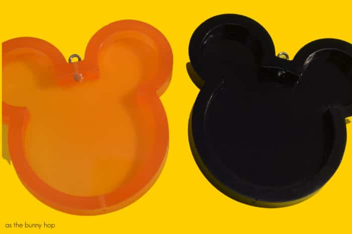 Disney Halloween Shakers on yellow background. Empty resin Mickeys. 