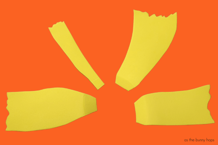 Yellow foam hair pieces for Cynthia headband on orange background. 

Hey 90s babies: Make your own Rugrats-Inspired DIY Cynthia headband! Get the full details on how to make your own over at As The Bunny Hops! 
