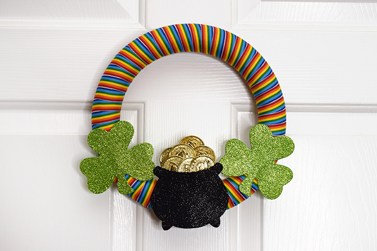 St. Patrick's Day Rainbow Wreath hanging on door.