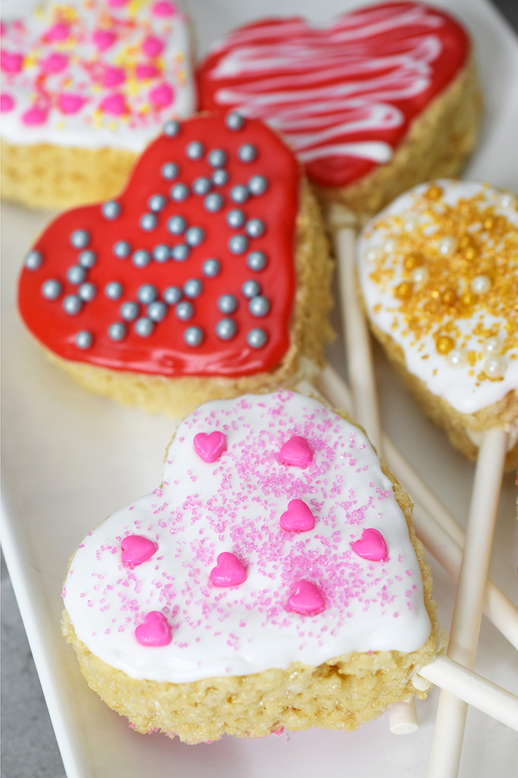plate with heart-shaped, rice krispy treat pops decorated for Valentine's Day