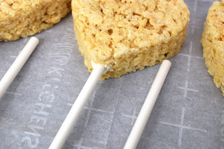 Add pop sticks to turn rice krispy treats into pops